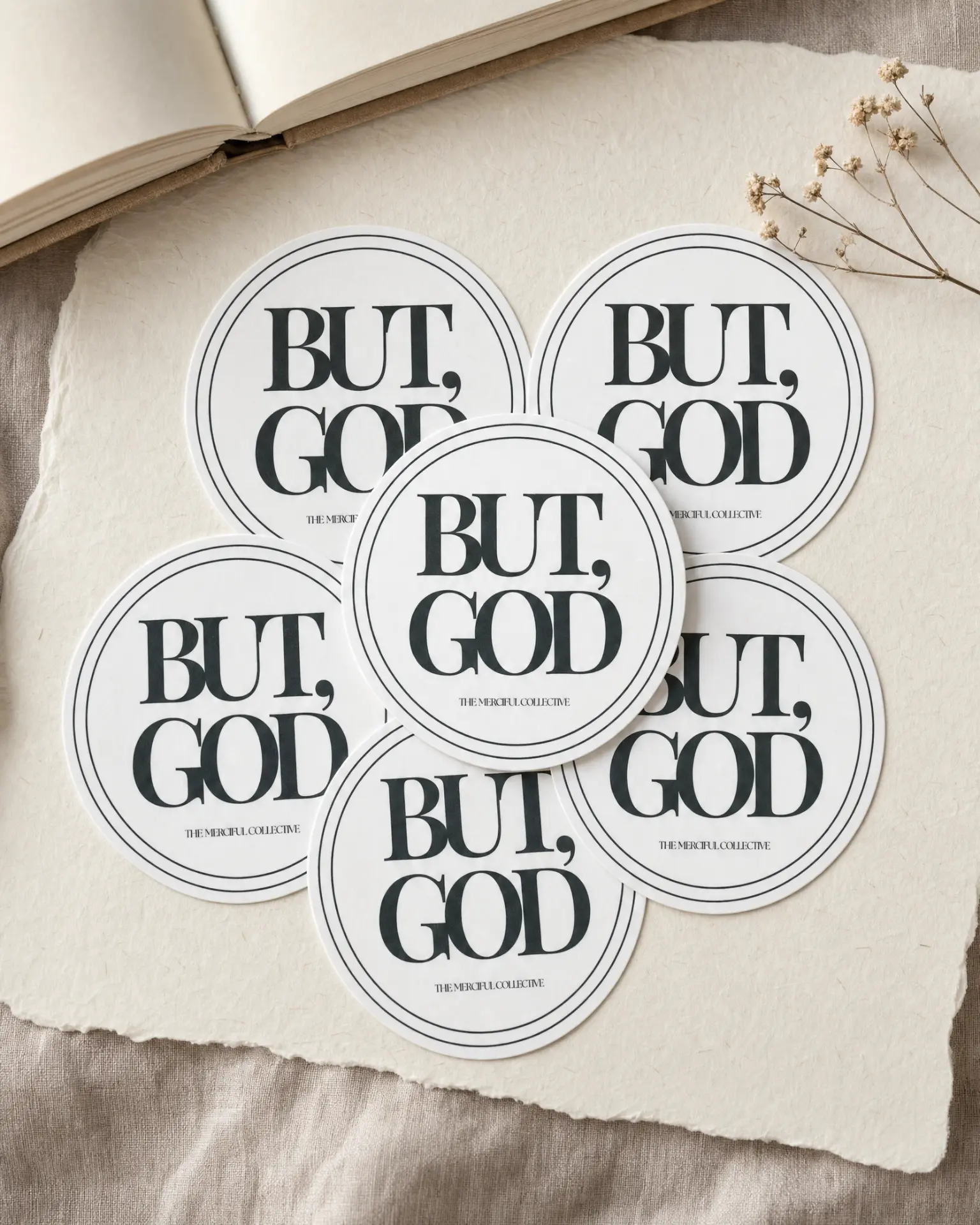Round But, God stickers on torn cream paper